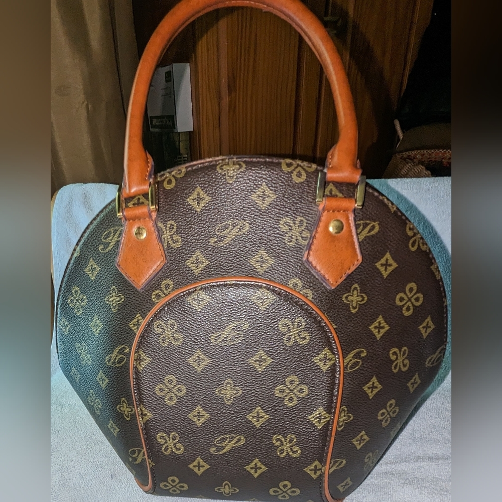 Vintage monogram ellipse faux canvas handbag.